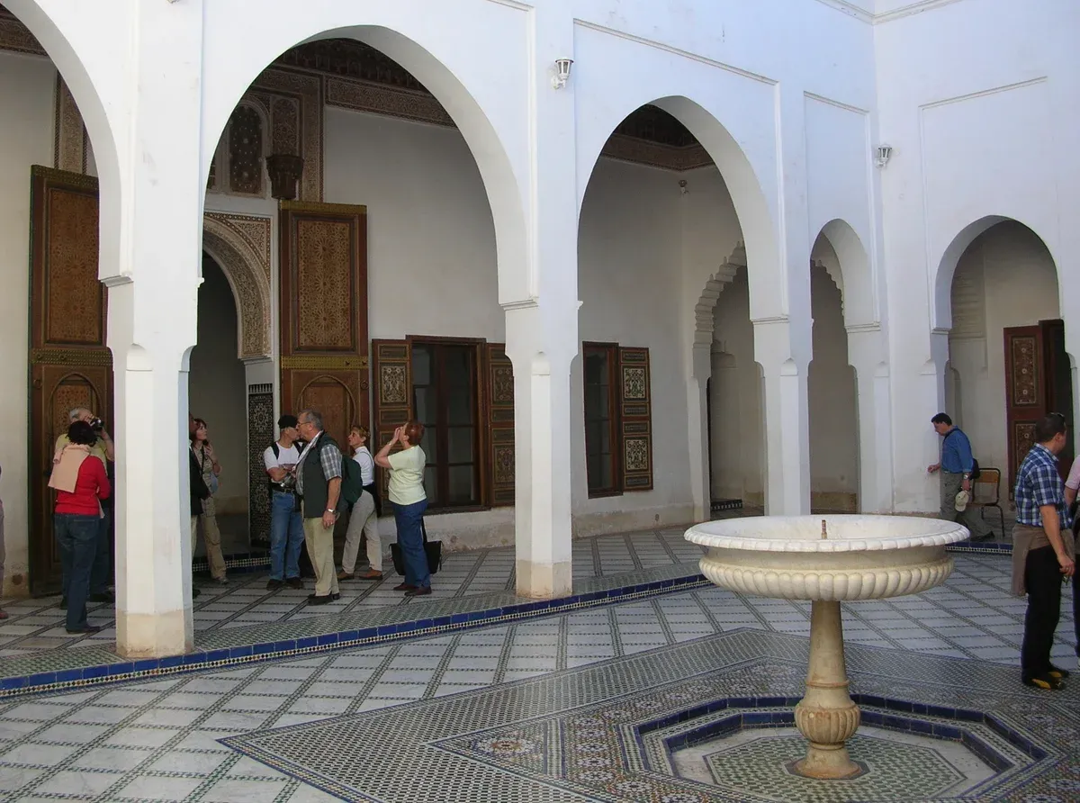 A courtyard with a tiled fountain inside Bahia Palace in Marrakech on a Morocco tour package, Bahia Palace, Marrakech, Morocco