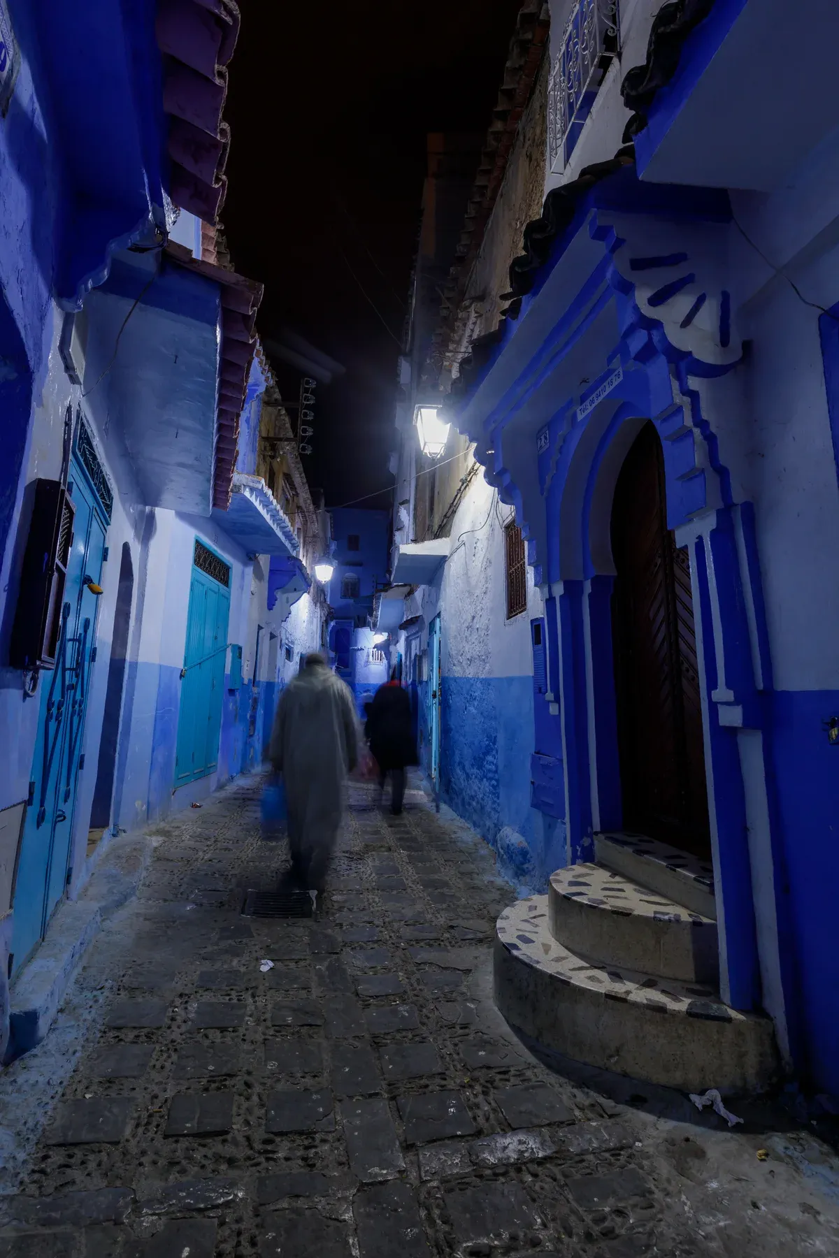 A blue-painted lane in Chefchaouen at night on a Morocco tour package