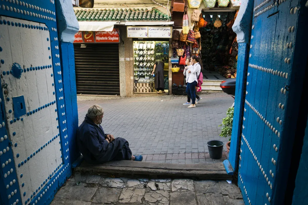 A blue-doored entrance into the Tangier medina on a Morocco tour package, Tangier medina, Morocco